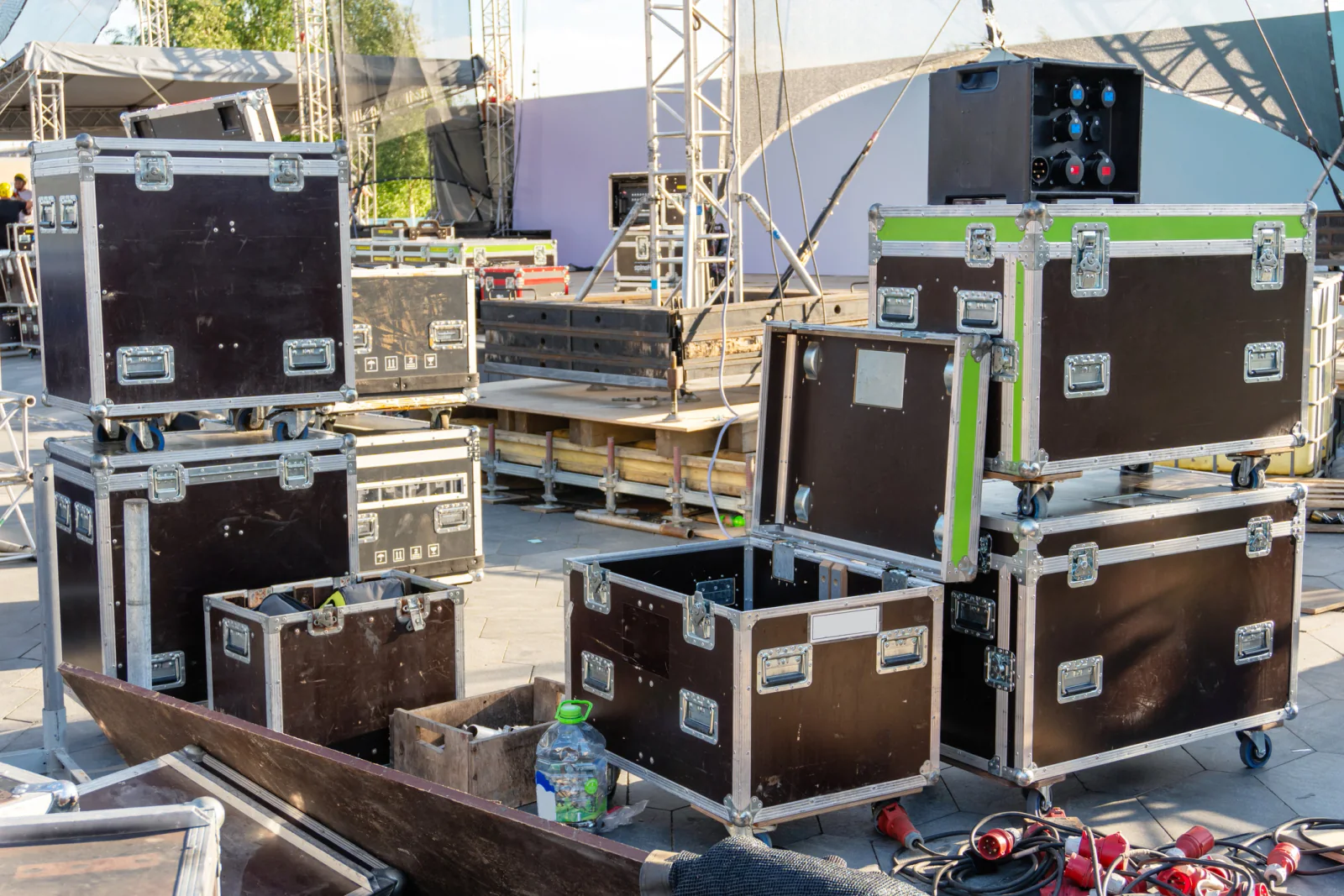 Large music festival operations area with staff using laptops, tablets, support displays, and event coordination equipment