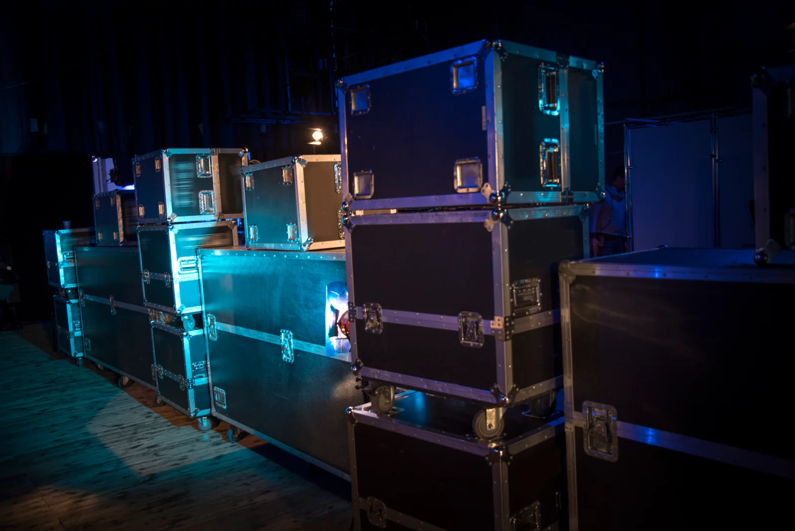 Concert show-day operations team with spare laptops, tablets, and support equipment prepared for fast recovery during a live event