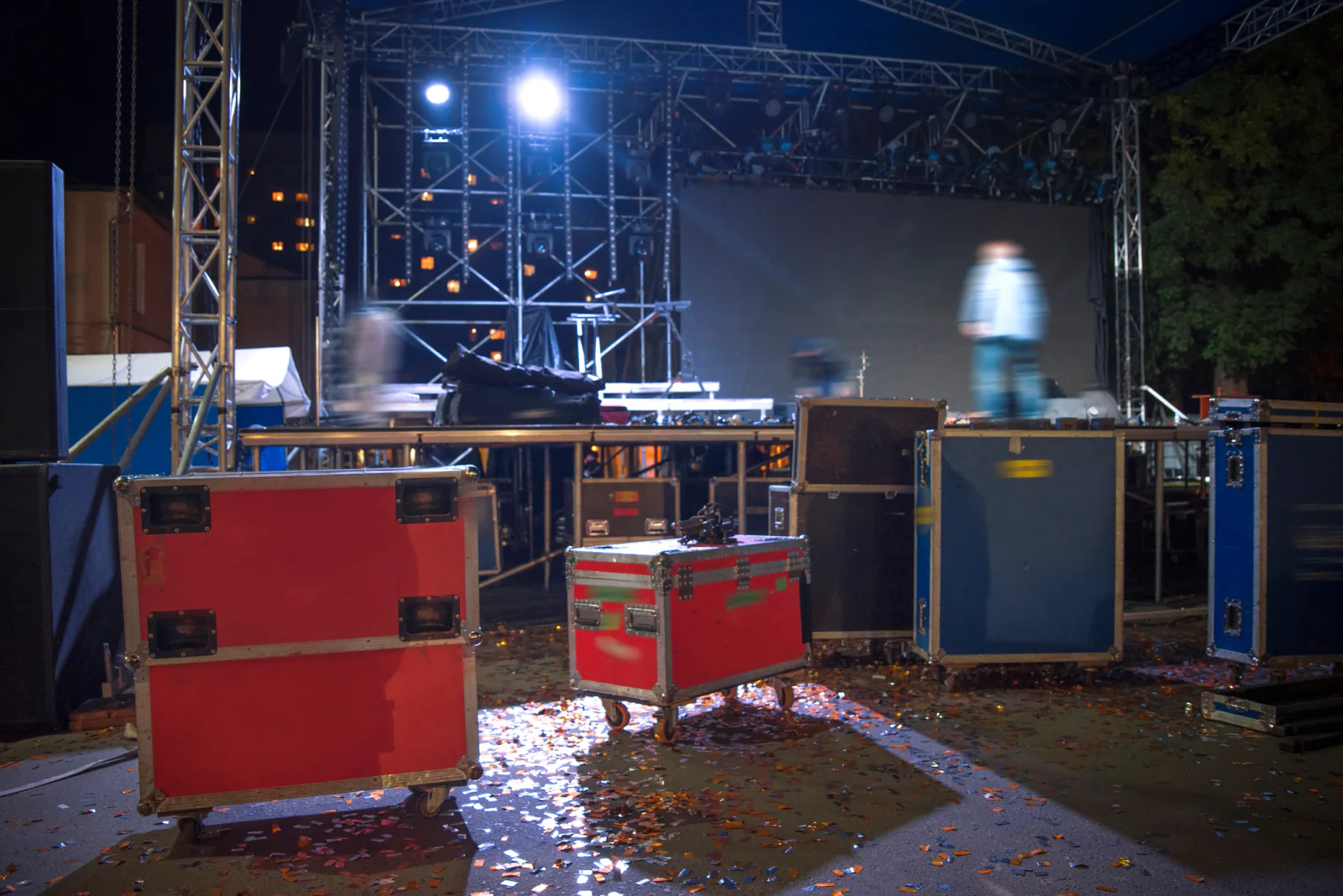 Touring concert production team using laptops, tablets, and support equipment to coordinate a multi-stop live music schedule
