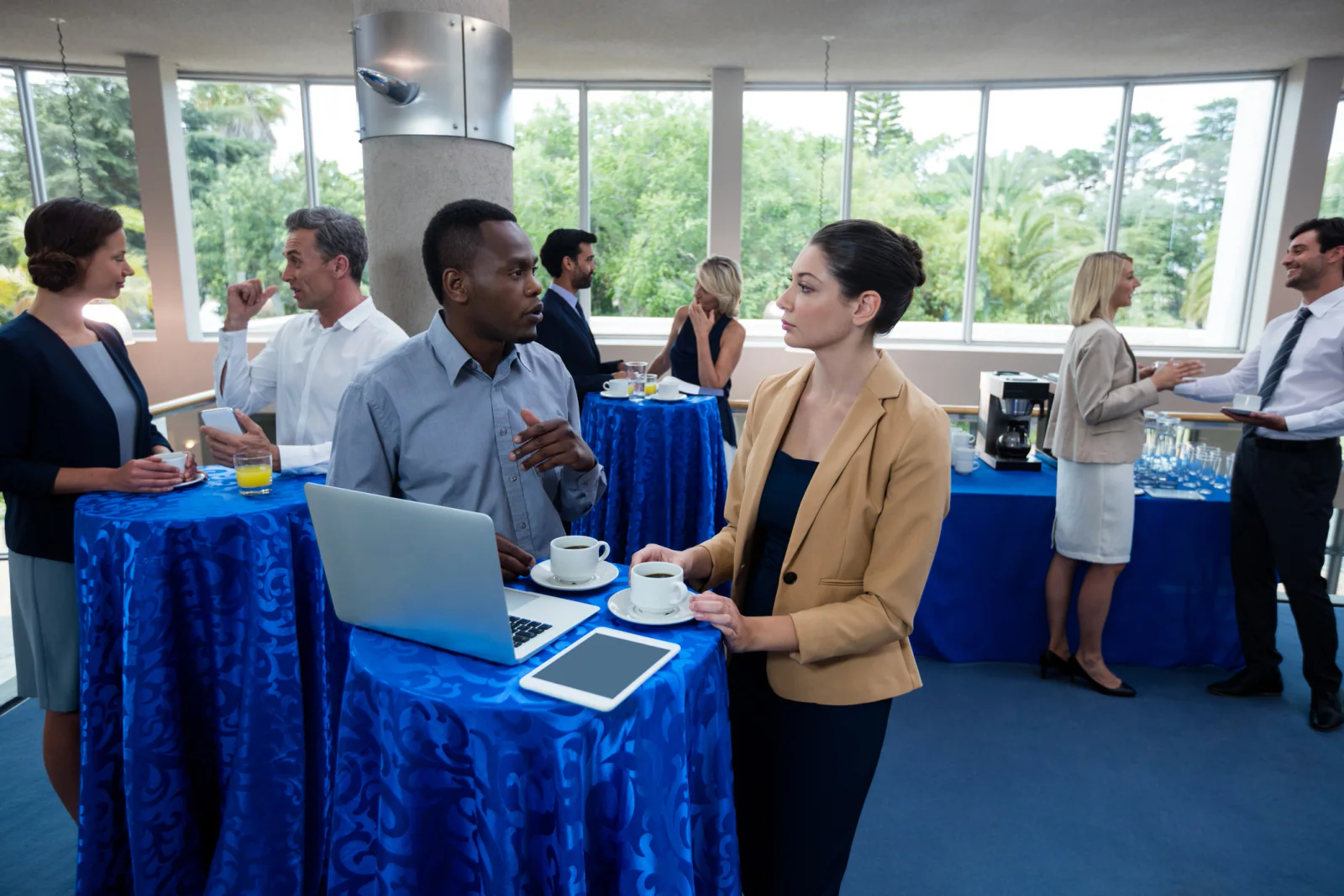 Product launch event with demo stations, presentation displays, and staff using event technology during a high-visibility release