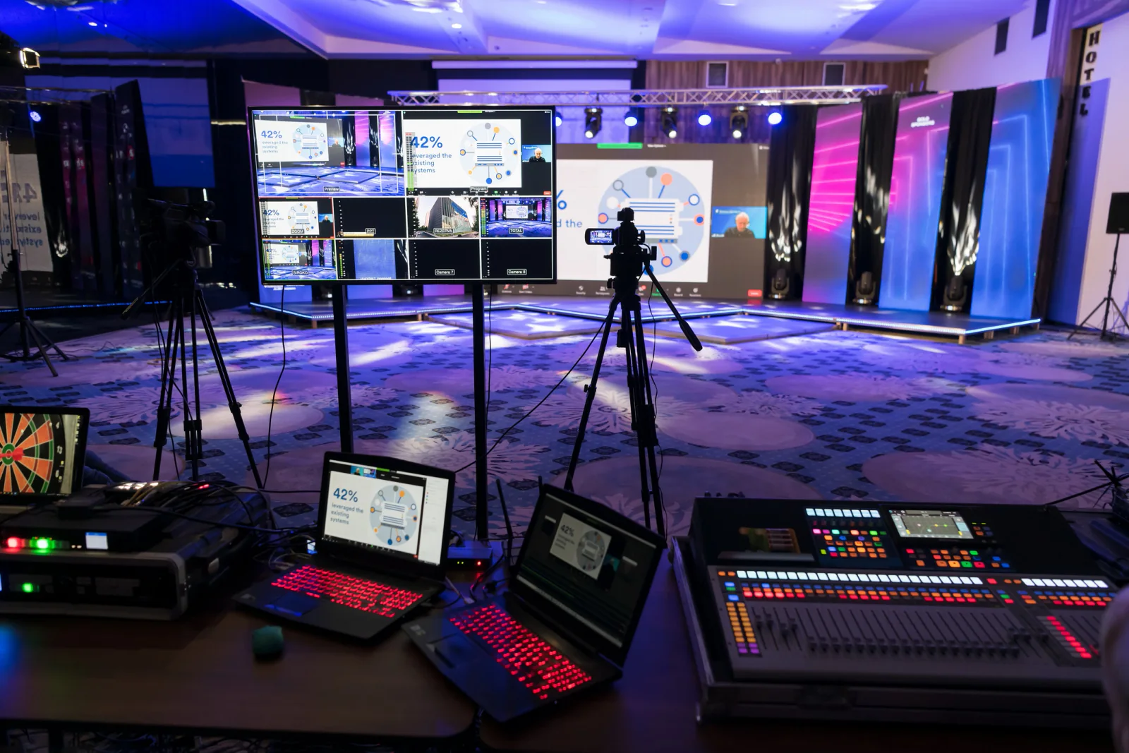 Sporting event credentialing and operations area with staff using tablets, laptops, and event workflow equipment