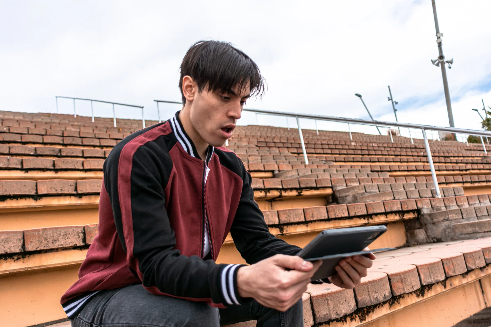 Sporting event field and venue coordination team using tablets and laptops to manage logistics across a large event footprint