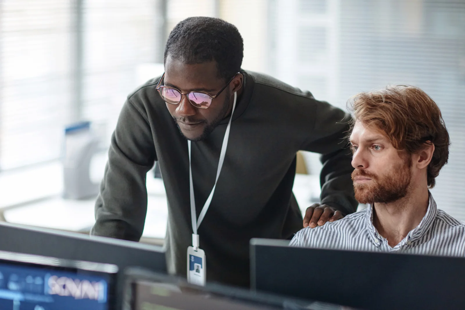 On-site IT support technician assisting staff with laptops, cables, and troubleshooting during a live event or business deployment