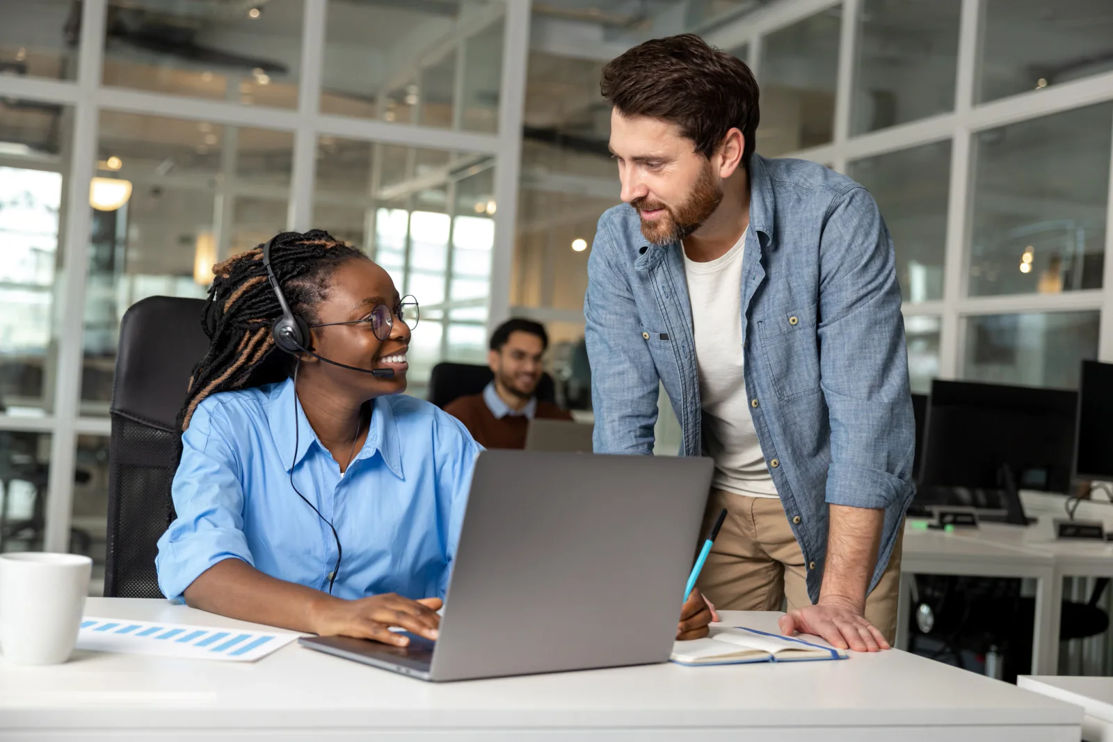 On-site IT technician troubleshooting laptops, displays, and accessories during a live go-live support window in a business environment