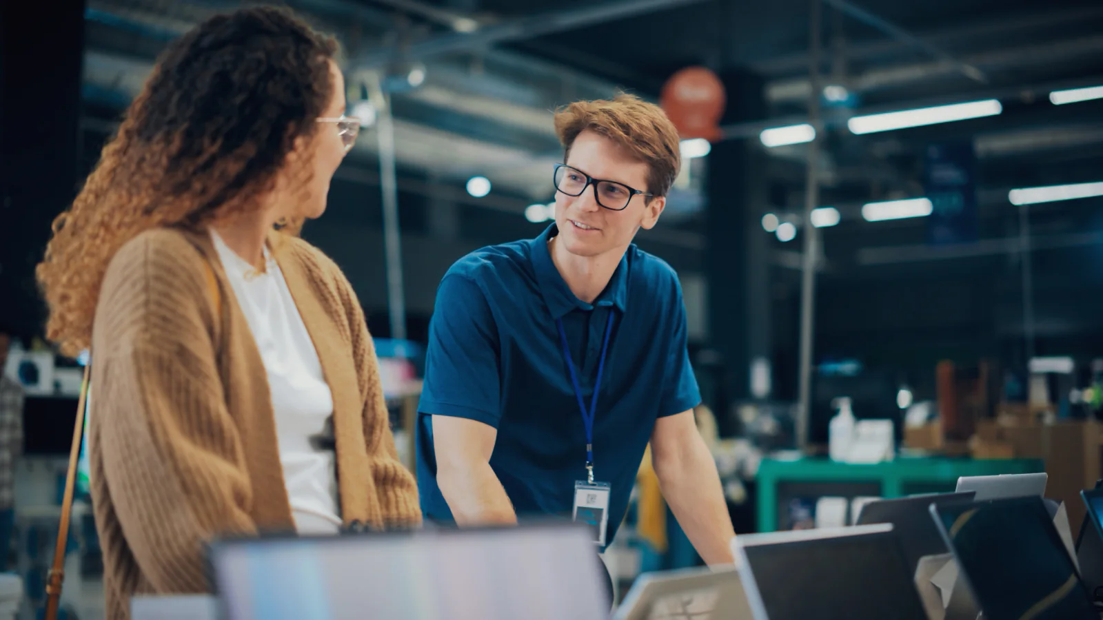 On-site IT technician supporting a classroom or training room with laptops, monitors, and instructor equipment during a live session