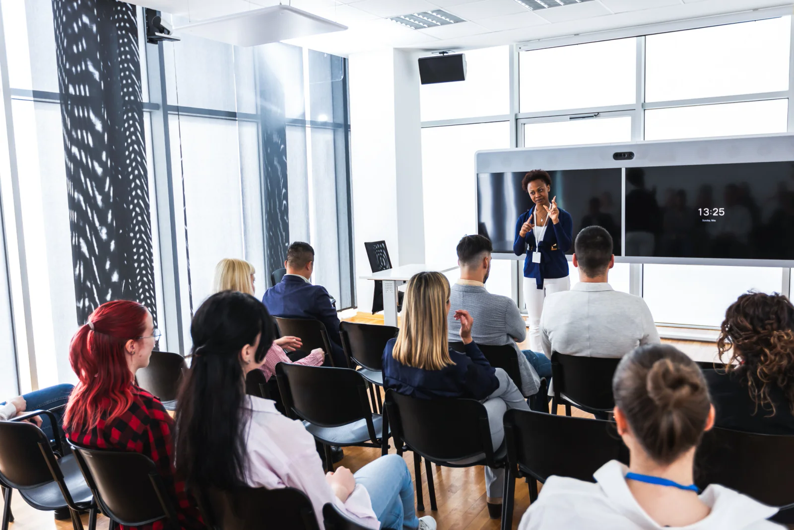 Training room with projection screen, instructor laptop, classroom seating, and presentation support for a workshop or training session
