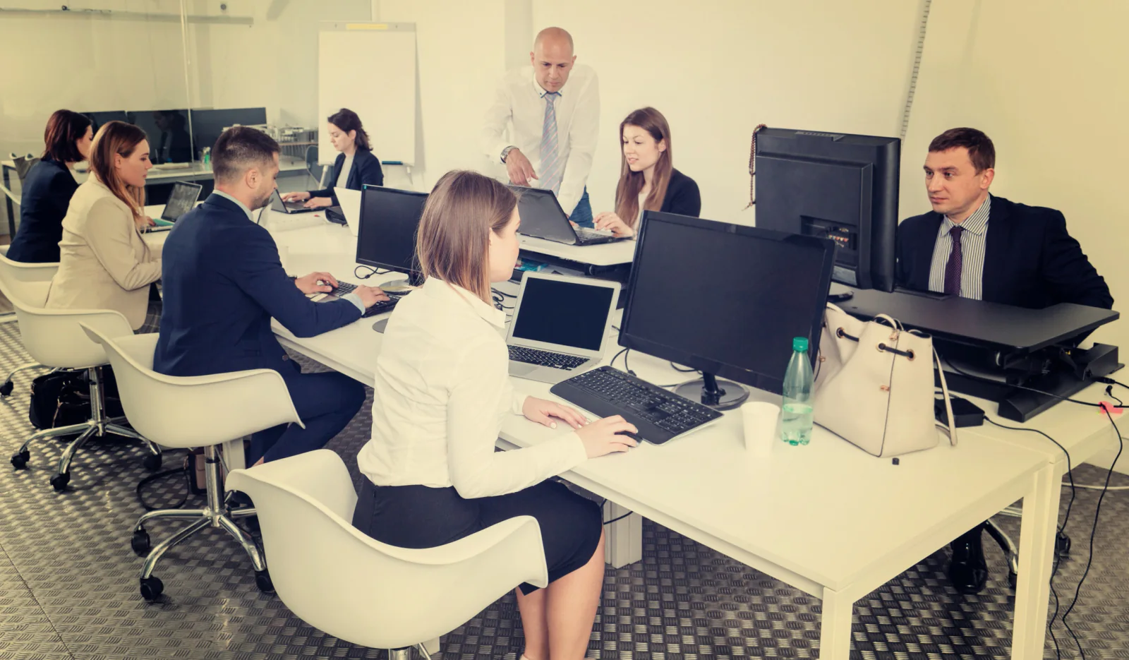 Temporary office or pop-up operations project with staged equipment, planning laptops, and coordination between business stakeholders