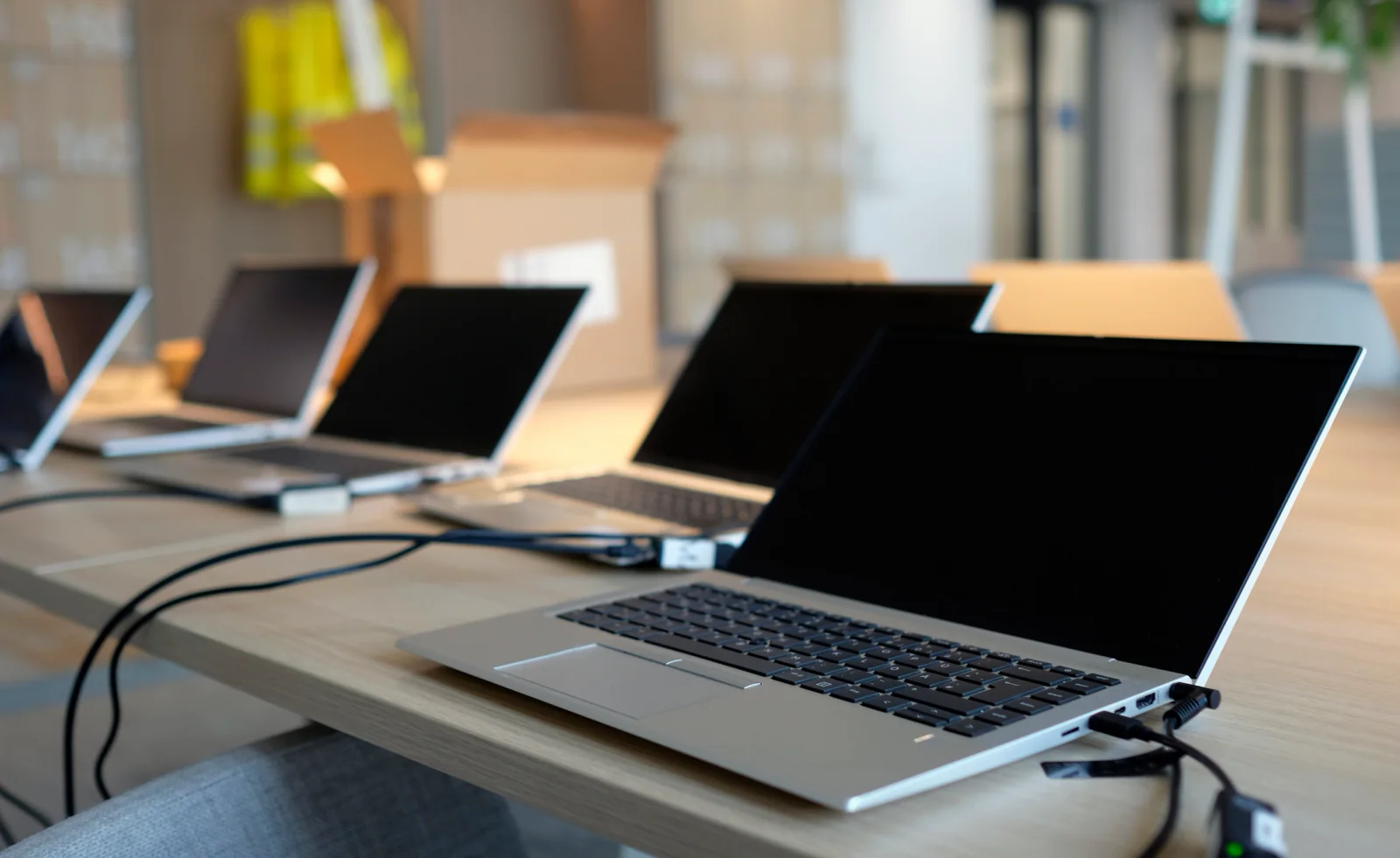 IT team imaging and provisioning multiple rental laptops with standardized software configuration in a staging environment