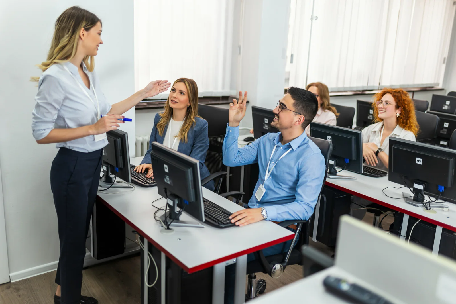 Instructor-led workshop or bootcamp with classroom laptops, presentation display, and standardized technology for learners