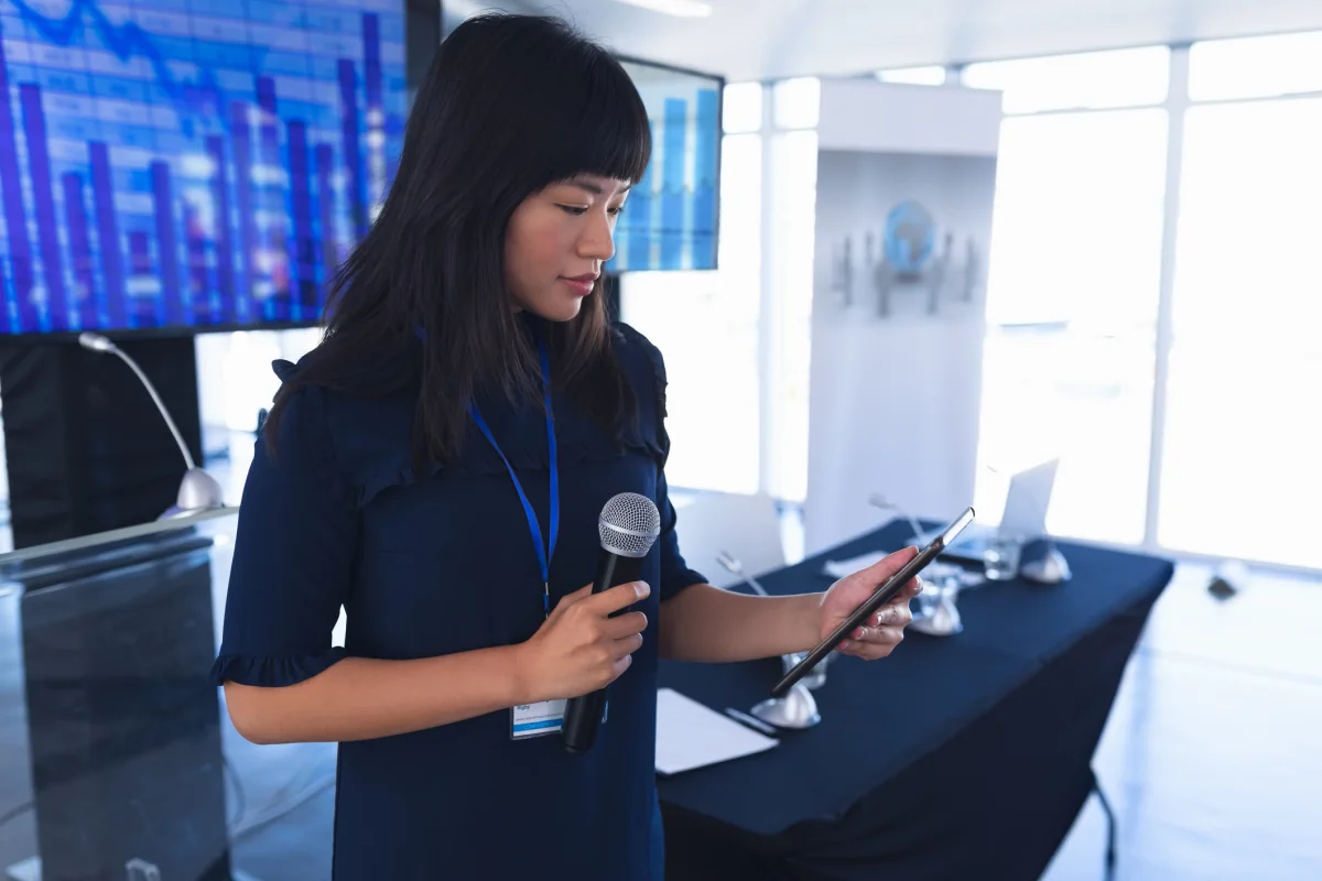 iPads on stands showing product demo content and branded interactive media at an event