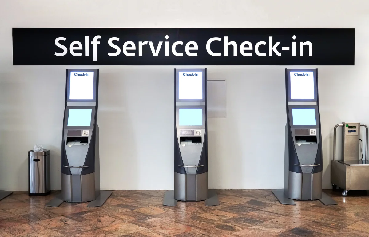 Row of tablet kiosks in a lobby used for self service registration, surveys, and attendee wayfinding