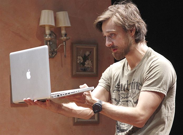 A person holding a rented MacBook Pro