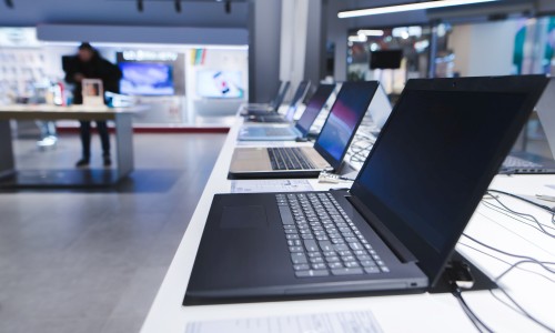 A variety of laptops on display at a retail store