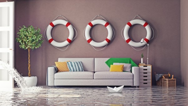 A couch amid water pouring into a living room