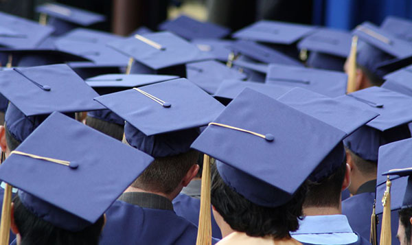 Recent graduates wearing graduation caps