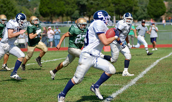 A football player rushing during a play