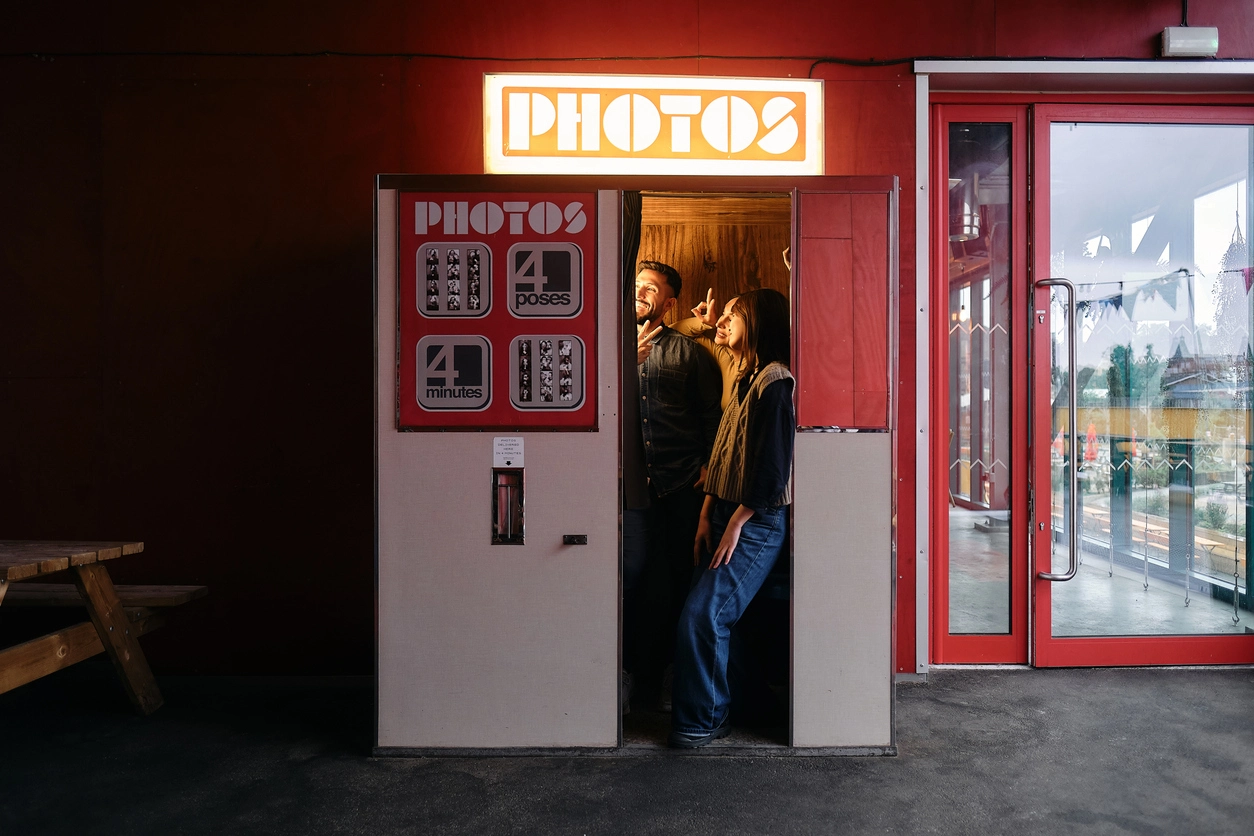 Branded photo booth experience at a professional event activation with attendees participating