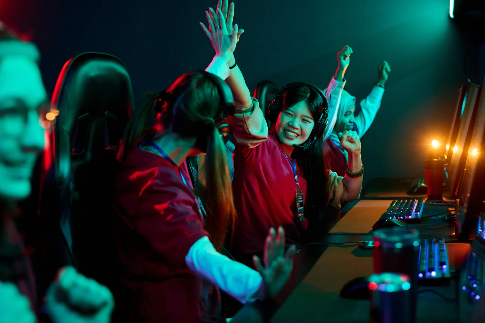 Trade show gaming activation with rental gaming rigs, large branded displays, and attendees engaging with an experiential booth