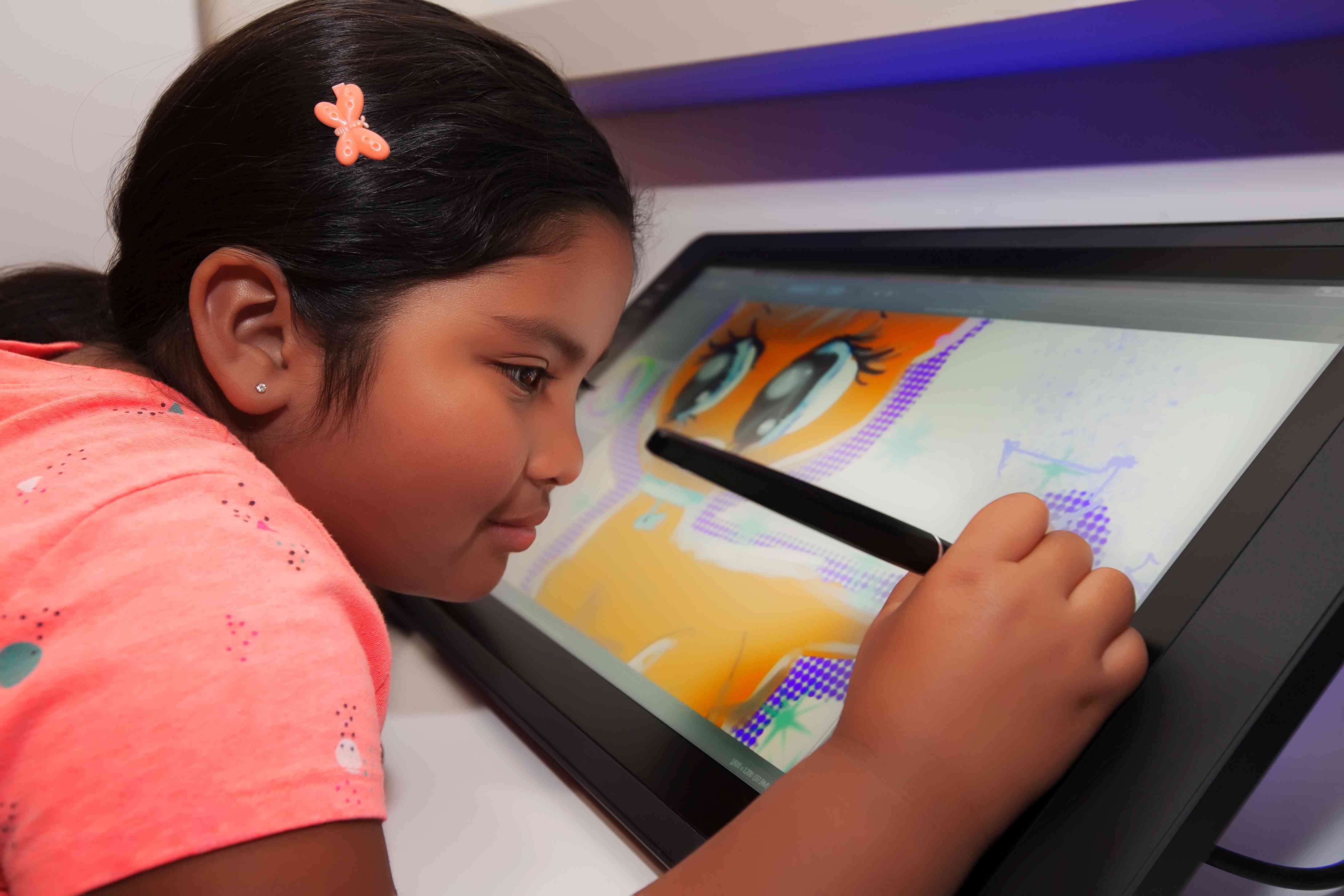 A child using a tablet to draw