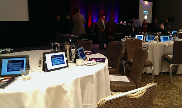 iPads set up on circular tables at an event