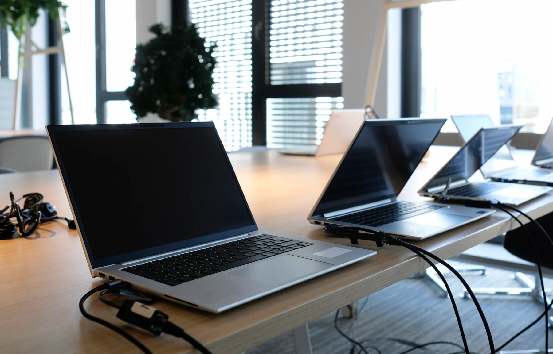 Technology rental pricing planning desk with laptops tablets paperwork and business budgeting materials
