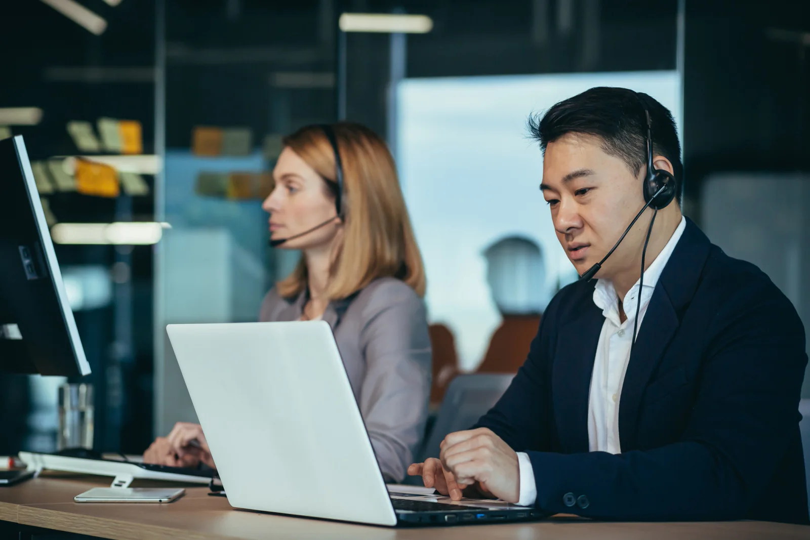 Helpdesk and support team using headsets, laptops, and cloud communication tools in a service operations environment